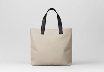 Beige tote bag with black handles on white background, perfect for stylish outings and everyday use. This versatile accessory combines functionality and elegance seamlessly
