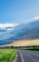 Road with a cloudy sky in the background