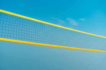 Beach volleyball court with blue summer sky, volleyball net, blue sky, outdoors