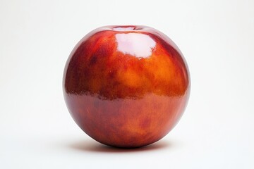 Obraz premium A single, ripe nectarine with a glossy, reddish-orange skin sits against a white background.