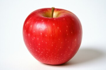 A single, ripe red apple sits on a white background, showcasing its vibrant color and smooth skin.