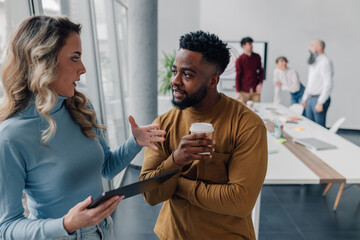 Business people talking and drinking coffee during office break