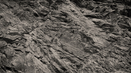 Black white dark gray stone rock granite background. Mountain surface texture. Close-up. Nature. For design