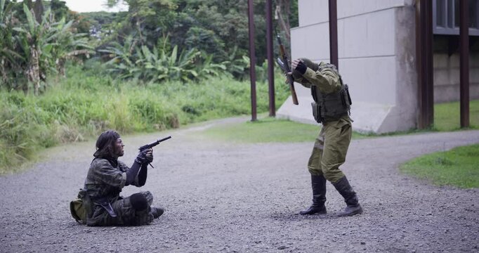 Spy interrogating scared solider out in open then shooting him - wide, side shot