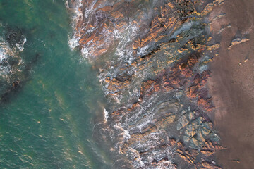 Aerial, Winter’s crashing tidal waves at Down Derry in Cornwall UK