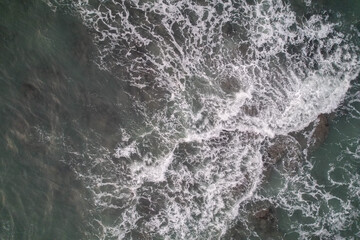 Aerial, Winter’s crashing tidal waves at Down Derry in Cornwall UK
