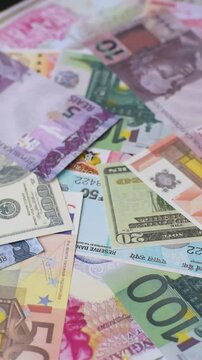 A background consisting of paper banknotes of different currencies of the USA, Europe, Brazil. Multicurrency background