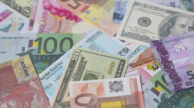 A background consisting of paper banknotes of different currencies of the USA, Europe, Brazil. Multicurrency background