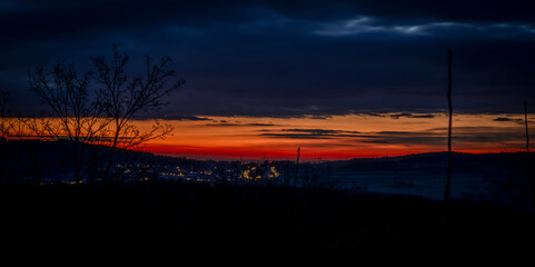 Obraz premium Orange sunrise with blue hour colors monastery near valley of river Donau
