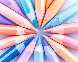 Pastel colored pencils arranged in a circle on a light background; ideal for art supplies advertising