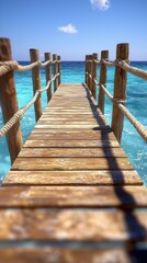 Obraz premium Walkway extends over clear ocean with blue sky and distant cloud background