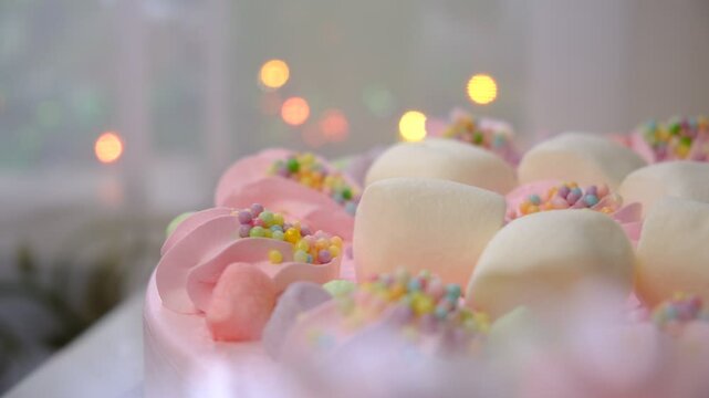 Arranged cream marshmallow cake, meringue, pink berry mousse. Festive event. Sweet food, perfect for children's parties. Details of dessert table. Decoration wedding party