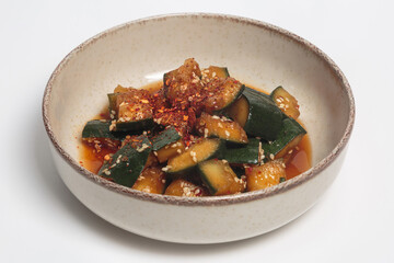 The image shows a bowl of a Korean-style cucumber salad. 