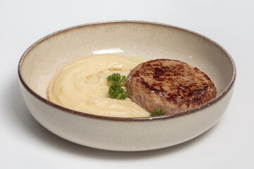 The image shows a cooked meat patty, likely made from ground pork or turkey, that has been seared to create a nicely browned exterior. 