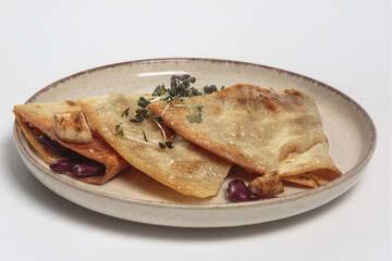 The image shows a plate with three quesadillas. 
