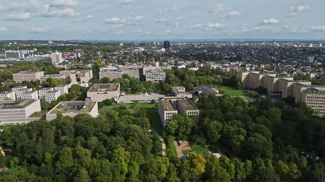 An aerial drone view of Goethe University Frankfurt in Frankfurt, Germany, showcasing the university's modern and historic buildings spread across a vibrant urban campus. 