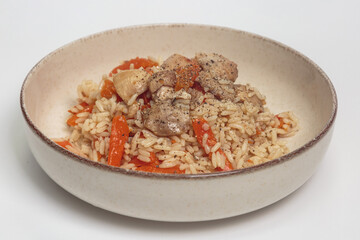 The image shows a bowl of rice dish with chicken and vegetables