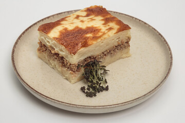 The image shows a slice of moussaka, a classic Greek baked dish. 