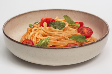 The image shows a plate of freshly prepared spaghetti with a vibrant tomato sauce.