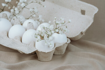 White Eggs with Babe Wreath Flowers in Open Carton.Natural healthy food and organic farming concept