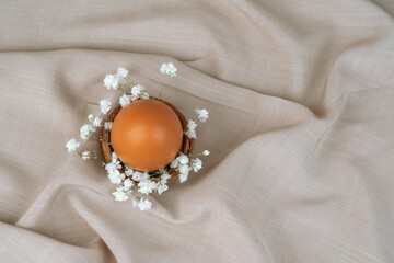 Brown egg in floral nest. Easter egg. Easter backgorund.