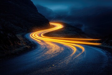 Winding mountain road at night, illuminated by long-exposure light trails of passing vehicles.