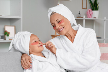 Little girl and her grandmother with under-eye patches at home