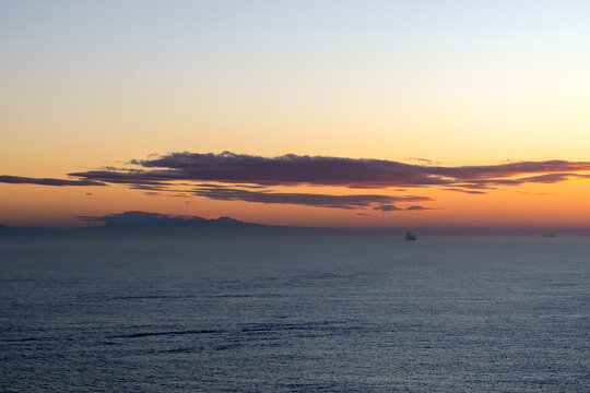Sunrise in the cruise port of Quetzal in Guatemala. In the background you can see a volcano in Guatemala as a silhouette.