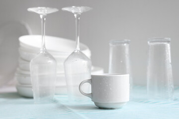 Set of different clean dishes on table in kitchen