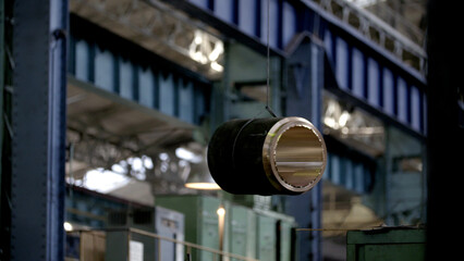 Crane holding pp pipe detail in industrial manufacturing plant