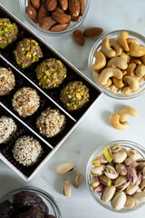 Handmade energy balls with nuts, dried fruits. healthy sweet snack, candy free sugar. raw dessert made from dates, apricot, almond, cashew, pistachio, sesame seed. Vegetarian organic food with