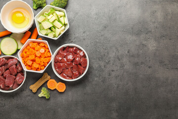 Pet food. Natural products on grey table, top view. Space for text