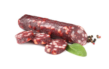 Delicious dry cured sausage and spices isolated on white