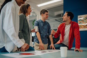 Marketing team discussing new project during informal office meeting