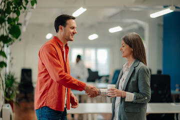 Businesspeople shaking hands in modern office during meeting