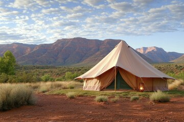 Intricately designed tent nestled in a stunning landscape, with soft lighting fostering a cozy ambiance for memorable glamping experiences.
