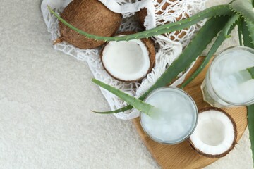 Refreshing drink with coconut and aloe on white textured table, flat lay. Space for text