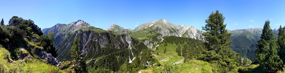 Panoramic view of the hiking trail ascent from Klostertal to Spullersee lake with the summits of Plattnitzerjochspitze, Spuller Schafberg and Blisadonaspitze, seen from Batzigg mountain in the Alps