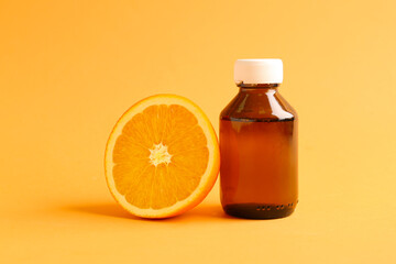 Cough syrup with orange on color background