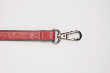 Maroon synthetic leather bag strap with key chain isolated on white background.Copy space for text.For graphic design,3D rendering or banner background