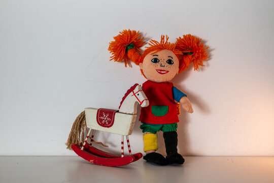 Famous character from Swedish children book - Pippi Longstocking and scandinavian rocking horse