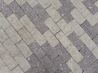 An elegant arrangement of beautifully paved stones, showcasing a blend of gray hues and intricate patterns. An Elegant Paved Surface Featuring Varied Textures and Colors for Enhanced Aesthetic Appeal