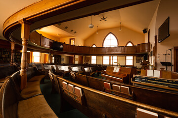 Rows of pews in an old country church.