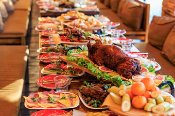 Lavish feast with roasted meat and assorted platters on a long dining table