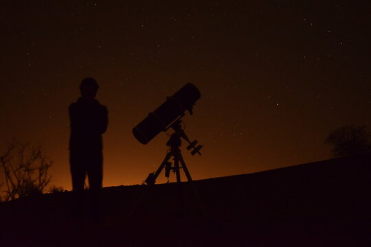 telescope at orange night sky