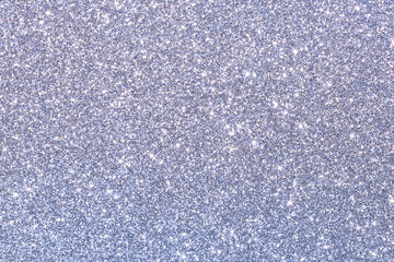 Fototapeta premium A blue and silver glittery background with a few small dots of color