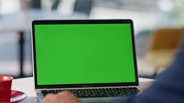 Businessman watching greenscreen laptop hotel lobby closeup. Man have video call