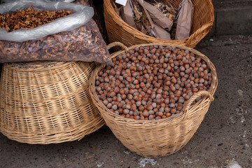 A village market with a wicker basket filled with hazelnuts.