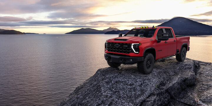 Red Chevrolet Silverado HD ZR2 Bison on Rocky Edge Overlooking Lake at Sunset