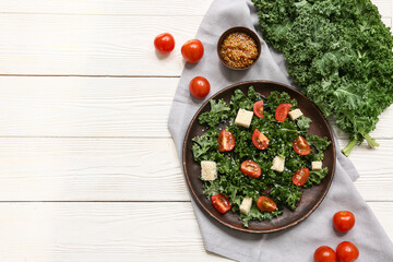 Composition with plate of tasty kale salad, tomatoes and Dijon mustard on light wooden background